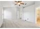 Bright bedroom featuring a ceiling fan and neutral decor, showing access to bathroom at 981 Piedmont Oaks Dr, Apopka, FL 32703