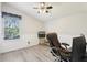 Well-lit room with wood-look floors and a ceiling fan, offering a great spot for a home office at 981 Piedmont Oaks Dr, Apopka, FL 32703