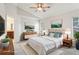 Bright bedroom featuring a ceiling fan, ensuite bath, and neutral decor at 981 Piedmont Oaks Dr, Apopka, FL 32703
