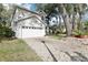 Home exterior featuring a brick driveway, lush lawn, and an attached two-car garage at 981 Piedmont Oaks Dr, Apopka, FL 32703