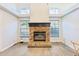 Living room showcasing a brick fireplace with black mantel and wood-look flooring at 981 Piedmont Oaks Dr, Apopka, FL 32703