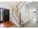 Light-filled foyer features hardwood floors, staircase, and elegant front door at 981 Piedmont Oaks Dr, Apopka, FL 32703