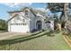 Charming two-story home featuring arched entryway, manicured lawn, and attached two-car garage at 981 Piedmont Oaks Dr, Apopka, FL 32703