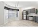 Kitchen with stainless steel appliances, gray cabinets, and a window filled eating nook at 981 Piedmont Oaks Dr, Apopka, FL 32703