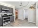 Bright kitchen boasts gray cabinets, stainless steel appliances, and laminate flooring at 981 Piedmont Oaks Dr, Apopka, FL 32703
