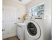 Laundry room showcasing a washer and dryer, a window and a side access door at 981 Piedmont Oaks Dr, Apopka, FL 32703