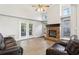 Comfortable living room with a brick fireplace, ceiling fan, and glass doors at 981 Piedmont Oaks Dr, Apopka, FL 32703