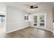 Bright living room with wood-look flooring and French doors leading to outdoor patio at 981 Piedmont Oaks Dr, Apopka, FL 32703