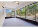 Enclosed patio with views of the tropical landscaped yard and an abundance of natural light at 981 Piedmont Oaks Dr, Apopka, FL 32703