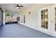 The enclosed back patio offers a ceiling fan and exterior doors for easy access to the backyard at 981 Piedmont Oaks Dr, Apopka, FL 32703