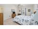 Cozy bedroom with a bed, window, ceiling fan, and dresser with mirror, creating a relaxing atmosphere at 992 Pinewood Pl, The Villages, FL 32162