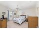 Serene bedroom featuring soft carpet, white walls, and coordinated decor at 992 Pinewood Pl, The Villages, FL 32162