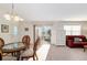 Open floor plan with dining area connecting to the living room and outdoor patio at 992 Pinewood Pl, The Villages, FL 32162