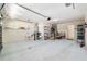 Spacious garage featuring overhead storage, utility sink, and convenient access to the home's interior at 992 Pinewood Pl, The Villages, FL 32162