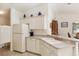 Well-maintained kitchen with white appliances, sink, and ample cabinet space at 992 Pinewood Pl, The Villages, FL 32162