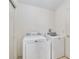 Functional laundry room with modern washer and dryer units for efficient chore management at 992 Pinewood Pl, The Villages, FL 32162