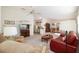 Bright living room with open floor plan, neutral carpet, and white walls at 992 Pinewood Pl, The Villages, FL 32162