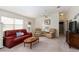 Inviting living room featuring comfortable seating, soft carpet and neutral walls at 992 Pinewood Pl, The Villages, FL 32162