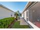 Outdoor patio offers charming space with shade and seating, perfect for relaxing and enjoying the outdoors at 992 Pinewood Pl, The Villages, FL 32162