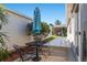Cozy outdoor patio setting featuring a table, chairs, and shade umbrella, perfect for enjoying the backyard at 992 Pinewood Pl, The Villages, FL 32162
