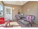 The screened-in porch features comfortable seating, a ceiling fan, and plenty of space for relaxation at 992 Pinewood Pl, The Villages, FL 32162
