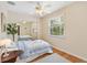 Bedroom with ceiling fan, window, and mirrored closet that amplifies space and light, enhancing its appeal at 1037 Willow Dr, Leesburg, FL 34748