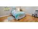 Bedroom featuring warm hardwood floors and a ceiling fan creating a cozy and inviting atmosphere at 1037 Willow Dr, Leesburg, FL 34748