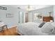Bedroom with hardwood flooring, a ceiling fan, and views to the outdoors, and multiple entries at 1037 Willow Dr, Leesburg, FL 34748