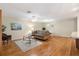 Inviting living room featuring hardwood floors, a ceiling fan, and comfortable seating at 1037 Willow Dr, Leesburg, FL 34748