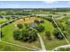 Expansive aerial view of property showcasing lush greenery and surrounding landscape with lakes and trees at 10901 Island Grove Rd, Clermont, FL 34711