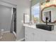 Stylish bathroom featuring sleek vanity, black sink, and walk-in shower at 10901 Island Grove Rd, Clermont, FL 34711