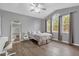 Modern bedroom with vaulted ceiling, large windows, and gray walls at 10901 Island Grove Rd, Clermont, FL 34711