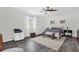 Bright bedroom with ceiling fan, neutral walls, and wood-look floors with rug at 10901 Island Grove Rd, Clermont, FL 34711