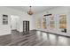 Dining room features french doors to the outside, a chandelier, and light grey laminate flooring at 10901 Island Grove Rd, Clermont, FL 34711