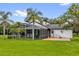 Back exterior with screened-in pool, patio, and backyard at 10901 Island Grove Rd, Clermont, FL 34711