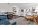 Open-concept living area showcases view of kitchen, wooden floors, and comfortable seating area at 10901 Island Grove Rd, Clermont, FL 34711