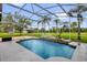 Screened pool with tropical foliage and patio at 10901 Island Grove Rd, Clermont, FL 34711