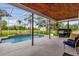 Inviting screened-in pool and patio area with grill at 10901 Island Grove Rd, Clermont, FL 34711