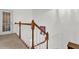 Bright staircase with wood railings and white spindles leading to the next level at 10901 Island Grove Rd, Clermont, FL 34711