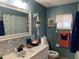 Cozy bathroom featuring marble countertop, decorative mirror, and modern fixtures with green accent paint and decor at 11250 Sw 78Th Ct, Ocala, FL 34476