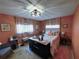 Inviting bedroom with warm-toned walls, stylish furniture, and ample natural light from two large windows at 11250 Sw 78Th Ct, Ocala, FL 34476