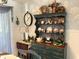 Charming dining area featuring a hutch filled with decorative dishware and a side table with lamp at 11250 Sw 78Th Ct, Ocala, FL 34476