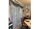 Cozy dining area with a window, decorative curtains and wallpaper, and an antique hutch nearby at 11250 Sw 78Th Ct, Ocala, FL 34476