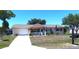 Charming single-story home featuring an attached garage, front porch with white picket fence, and well-maintained landscaping at 11250 Sw 78Th Ct, Ocala, FL 34476