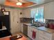 Kitchen featuring stainless steel appliances, white cabinetry, and a stylish brick backsplash at 11250 Sw 78Th Ct, Ocala, FL 34476