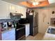 Well-lit kitchen featuring white cabinets, stainless steel appliances, and brick-look backsplash at 11250 Sw 78Th Ct, Ocala, FL 34476