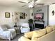 Cozy living room featuring an electric fireplace, TV, and comfortable seating at 11250 Sw 78Th Ct, Ocala, FL 34476