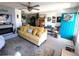 Bright and airy living room with a yellow sofa, fireplace, and blue front door at 11250 Sw 78Th Ct, Ocala, FL 34476