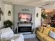 Stylish living room with fireplace, television, and yellow sofa at 11250 Sw 78Th Ct, Ocala, FL 34476