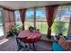 Charming sunroom with large windows, cozy seating, and ample natural light at 11250 Sw 78Th Ct, Ocala, FL 34476